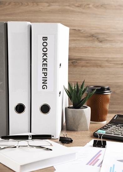 Professional bookkeeping with calculator and financial documents